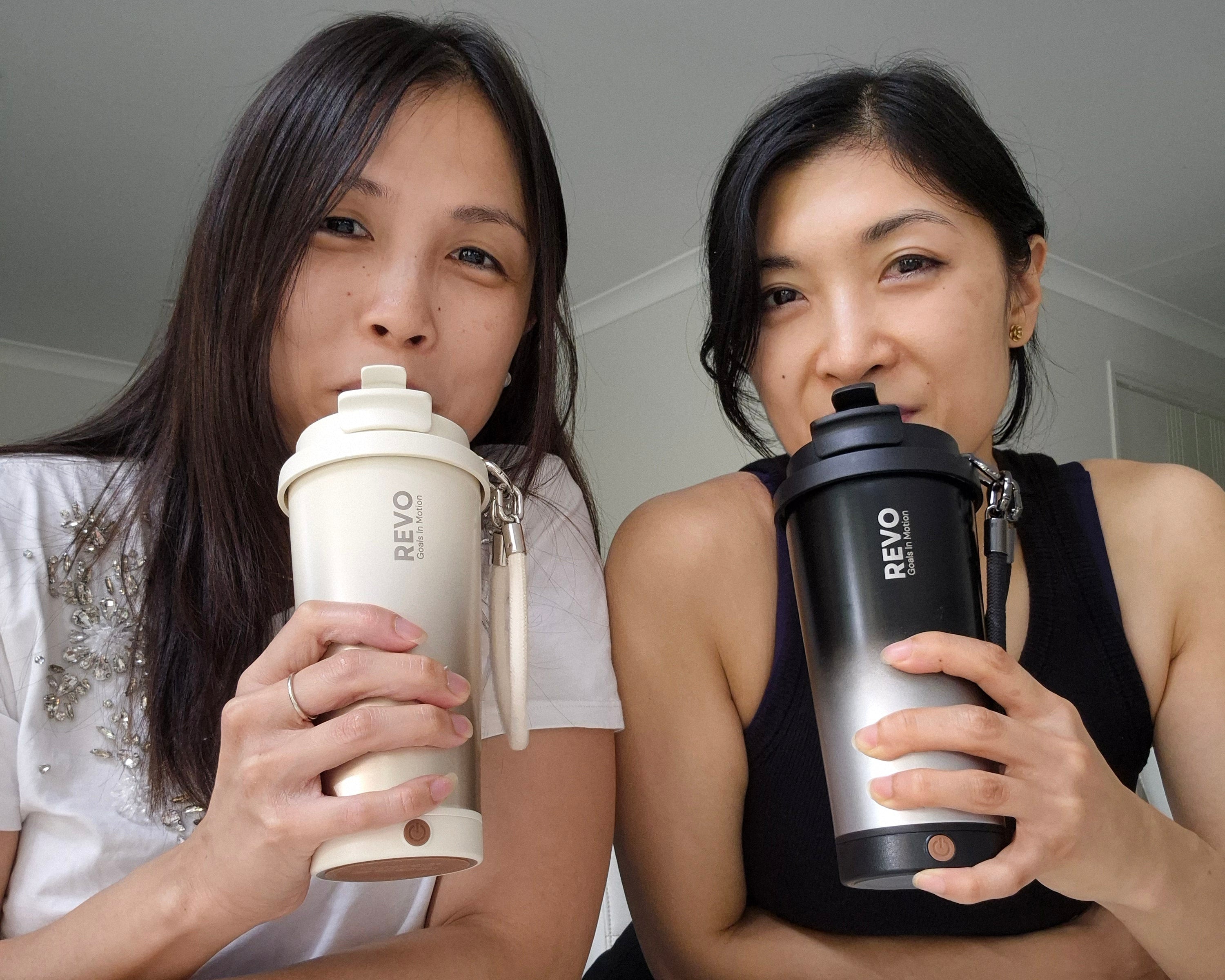Two women who are the founder of Revo Drinkware holding REVO brand cups against a neutral background